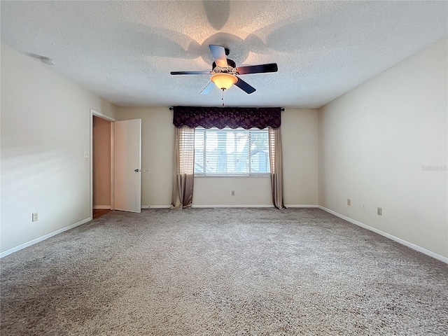 carpeted spare room with ceiling fan and a textured ceiling