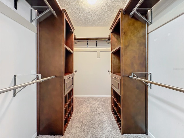 spacious closet featuring light carpet