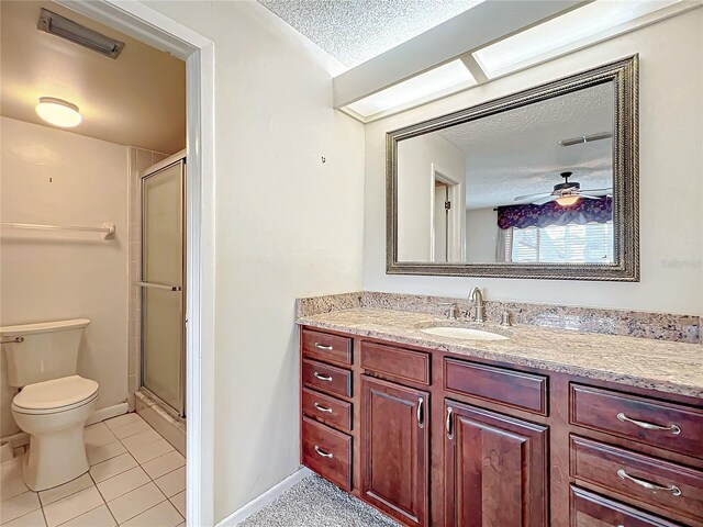 bathroom featuring tile patterned floors, vanity, a textured ceiling, ceiling fan, and a shower with shower door