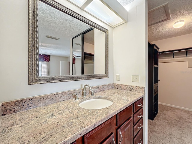 bathroom with vanity and a textured ceiling