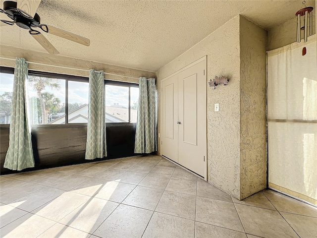 unfurnished sunroom featuring ceiling fan