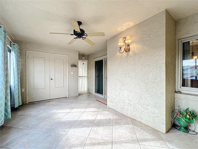 interior space with ceiling fan