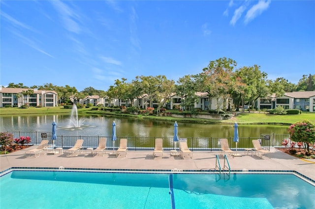 view of pool with a water view and a patio area