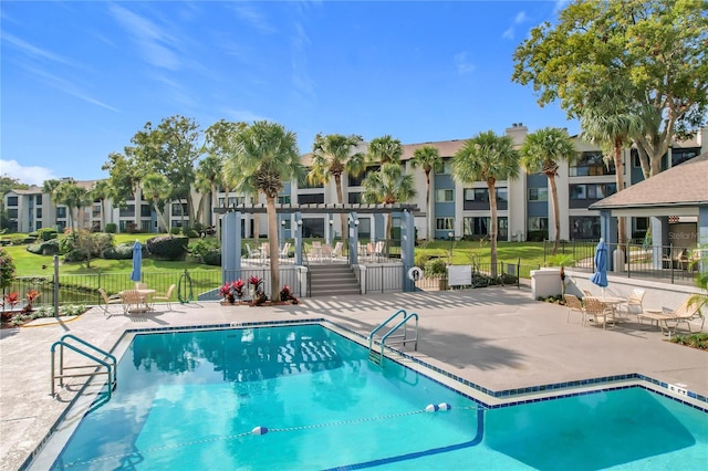 view of swimming pool featuring a pergola, a patio, and a yard