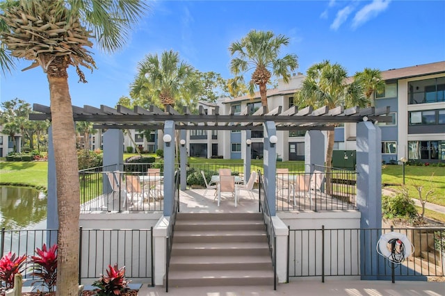 exterior space with a pergola and a water view