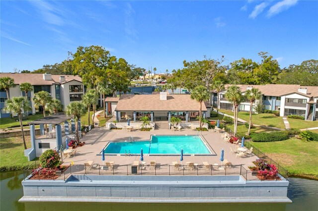 view of pool featuring a patio area and a water view