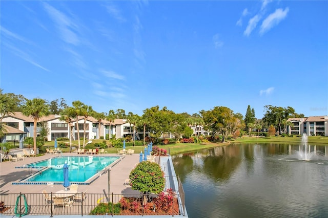 view of swimming pool featuring a water view