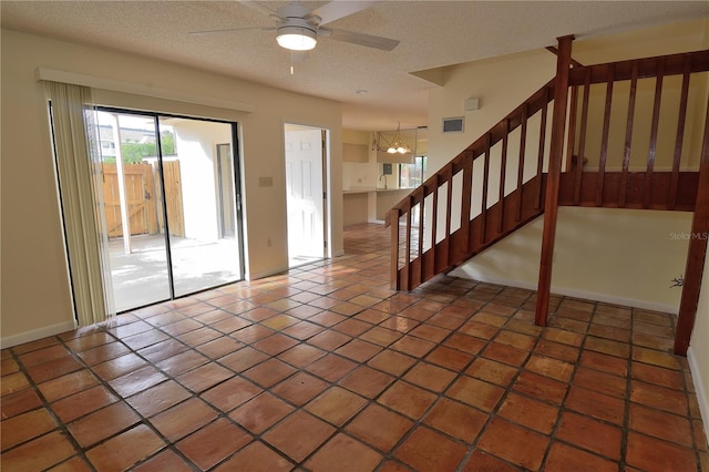 interior space with ceiling fan and a textured ceiling