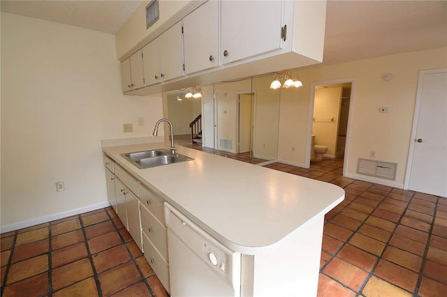 kitchen featuring white cabinets, dishwasher, kitchen peninsula, and sink