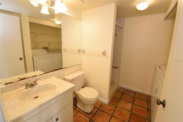 bathroom featuring a shower, washer and clothes dryer, vanity, and toilet