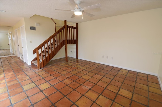 spare room with ceiling fan and a textured ceiling