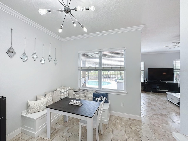 dining space with ceiling fan with notable chandelier, a textured ceiling, and crown molding