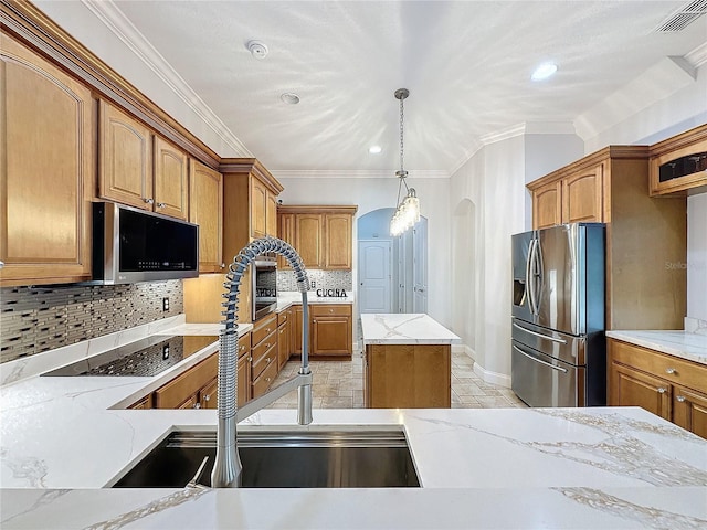 kitchen featuring decorative backsplash, a center island, stainless steel appliances, and crown molding