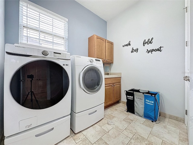 washroom featuring cabinets and independent washer and dryer