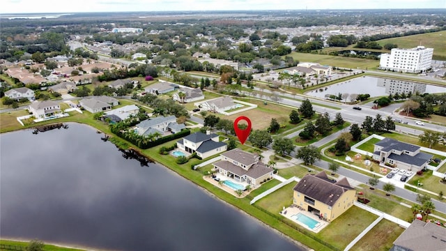 birds eye view of property with a water view