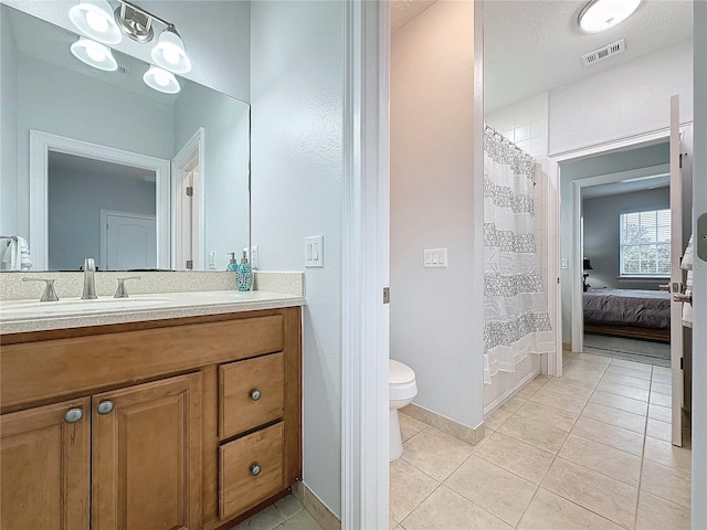 bathroom featuring tile patterned floors, vanity, toilet, and a shower with curtain