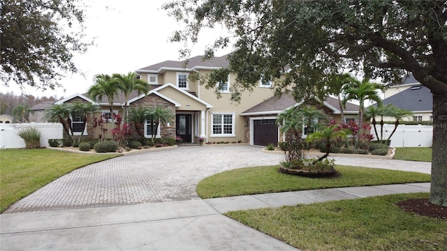 view of front facade with a garage and a front lawn