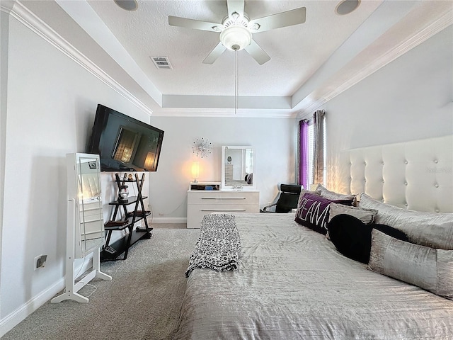 carpeted bedroom featuring a raised ceiling and ceiling fan