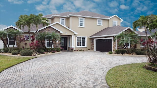 3301 Buckingham Way, Saint Cloud, FL 34772 - view of front facade with decorative driveway, an attached garage, stucco siding, stone siding, and a front lawn