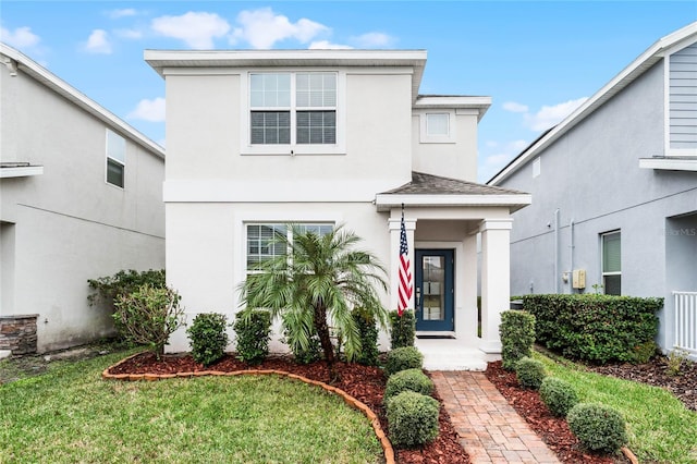 front facade with a front yard