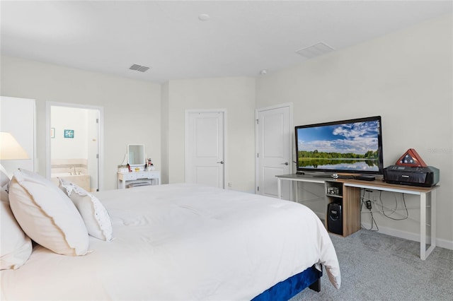 carpeted bedroom featuring ensuite bath