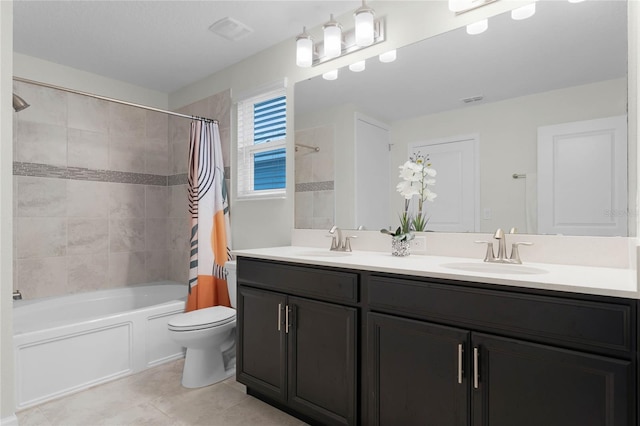 full bathroom featuring tile patterned floors, shower / bath combo with shower curtain, vanity, and toilet