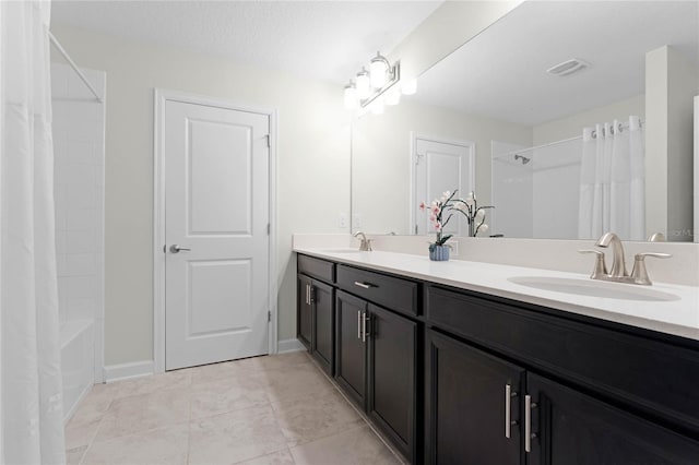 bathroom featuring a textured ceiling, vanity, tile patterned floors, and shower / bathtub combination with curtain