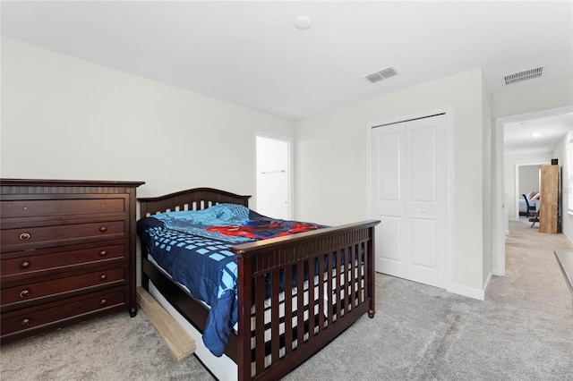 bedroom with light carpet and a closet