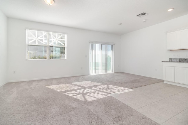 unfurnished living room with light carpet