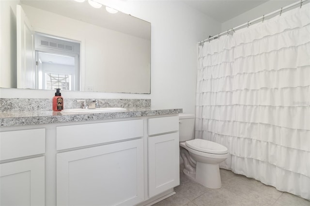 full bathroom featuring tile patterned floors, vanity, toilet, and shower / tub combo with curtain