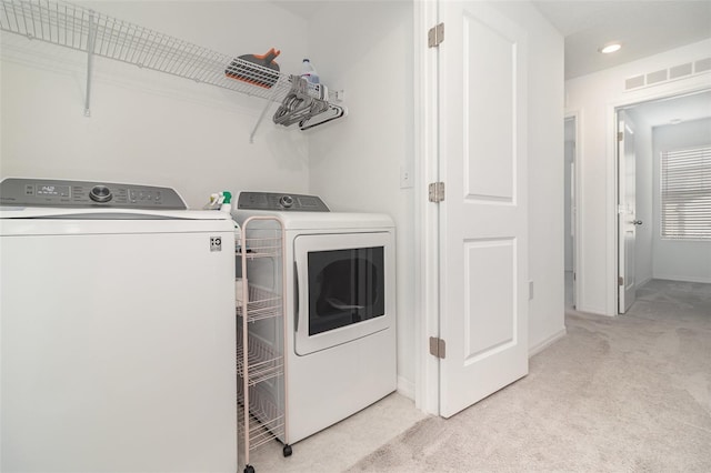 laundry room featuring light colored carpet and independent washer and dryer