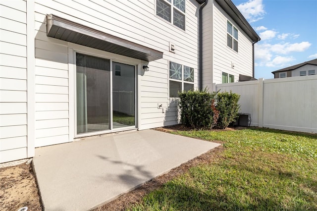 back of house featuring a lawn and a patio