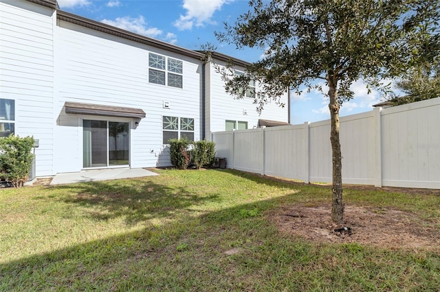 rear view of property featuring a lawn