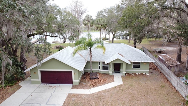 view of front facade featuring a garage and a water view