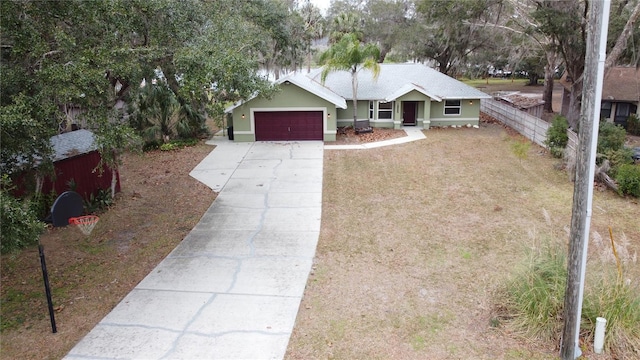 ranch-style house with a garage and a front lawn