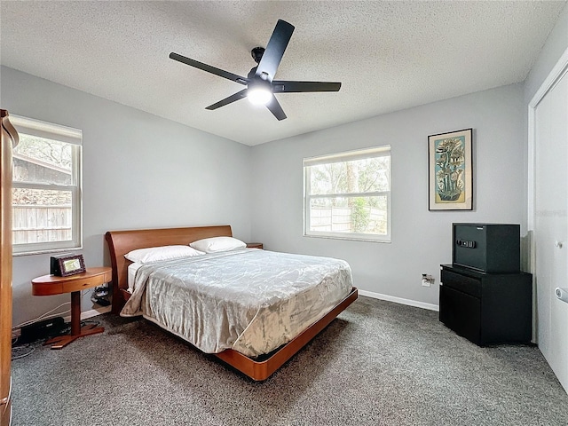 carpeted bedroom featuring a textured ceiling and ceiling fan