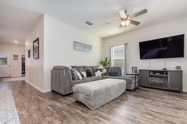 living room featuring ceiling fan and wood-type flooring