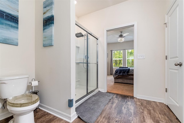 bathroom featuring hardwood / wood-style floors, ceiling fan, toilet, and walk in shower