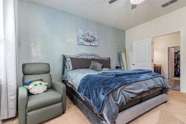 bedroom featuring connected bathroom, ceiling fan, carpet floors, and a spacious closet