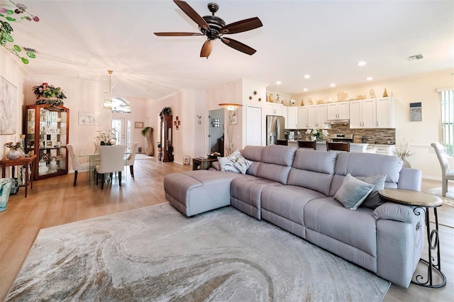 living room with ceiling fan and light hardwood / wood-style floors