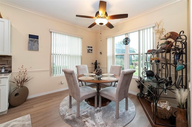 dining room featuring ceiling fan, light wood-type flooring, and ornamental molding