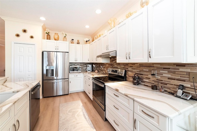 kitchen featuring backsplash, light stone counters, stainless steel appliances, crown molding, and white cabinetry