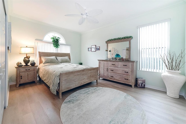 bedroom with light hardwood / wood-style flooring, ceiling fan, and crown molding