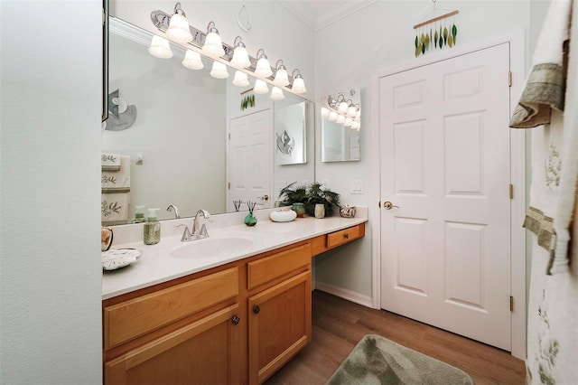 bathroom featuring hardwood / wood-style floors, vanity, and ornamental molding