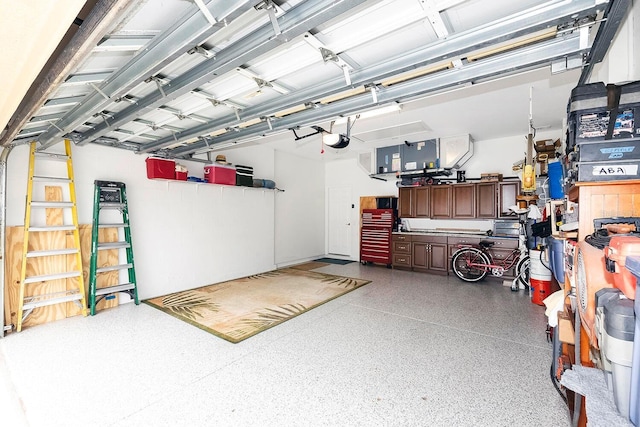 garage with a workshop area and a garage door opener