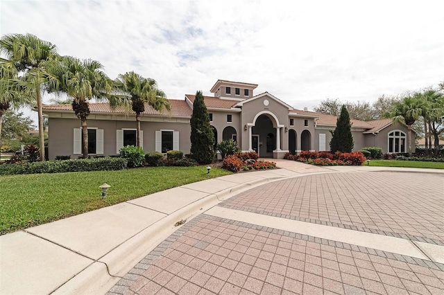 mediterranean / spanish house featuring a front yard