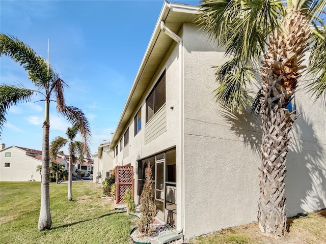 view of side of property with a yard