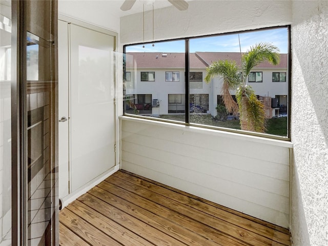 unfurnished sunroom featuring ceiling fan