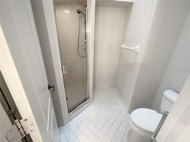 bathroom featuring toilet, tile patterned flooring, and walk in shower