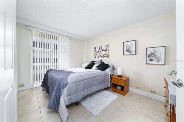 bedroom featuring a textured ceiling and light tile patterned flooring